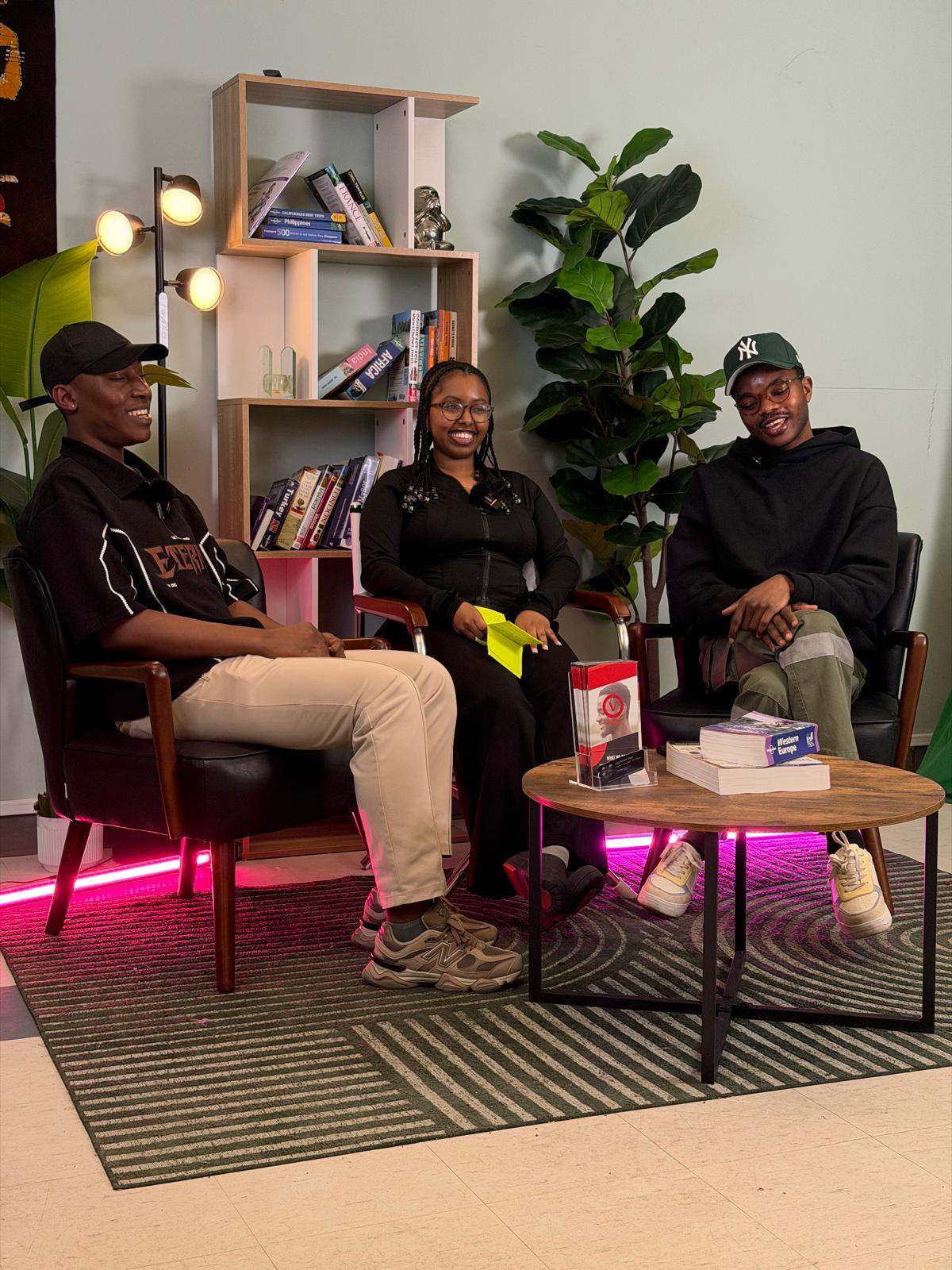Three young adults seated in a discussion space
