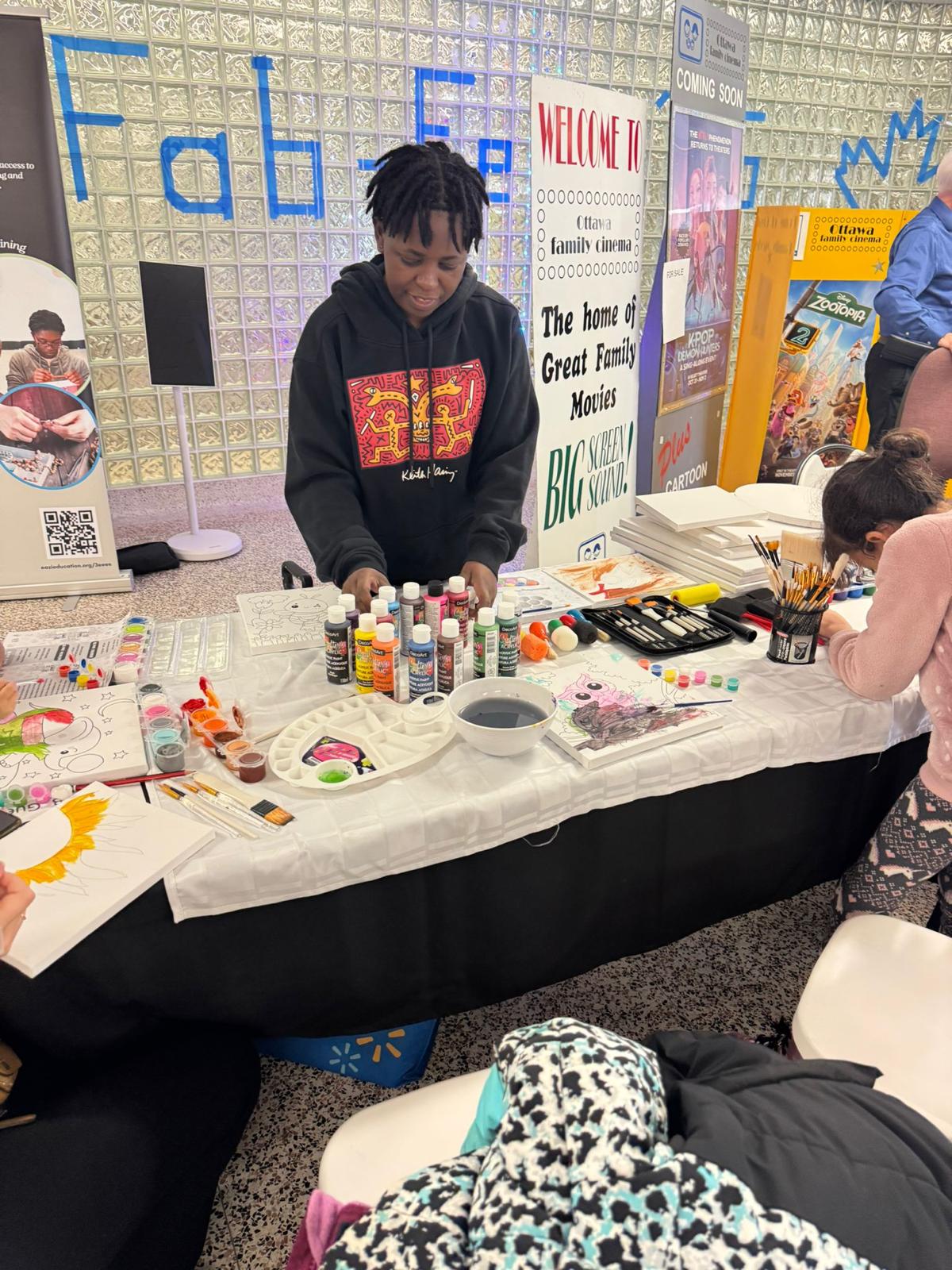 Youth facilitating a hands-on painting activity