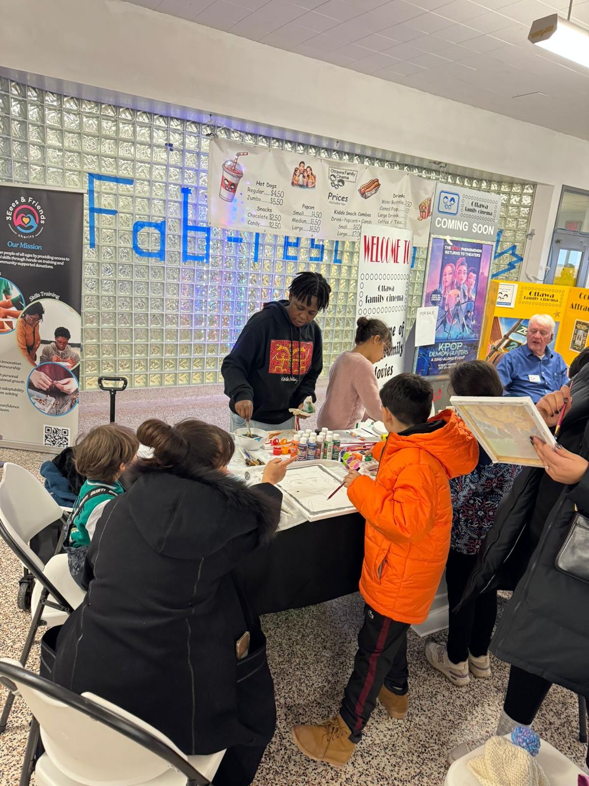 A community booth with painting supplies and participants