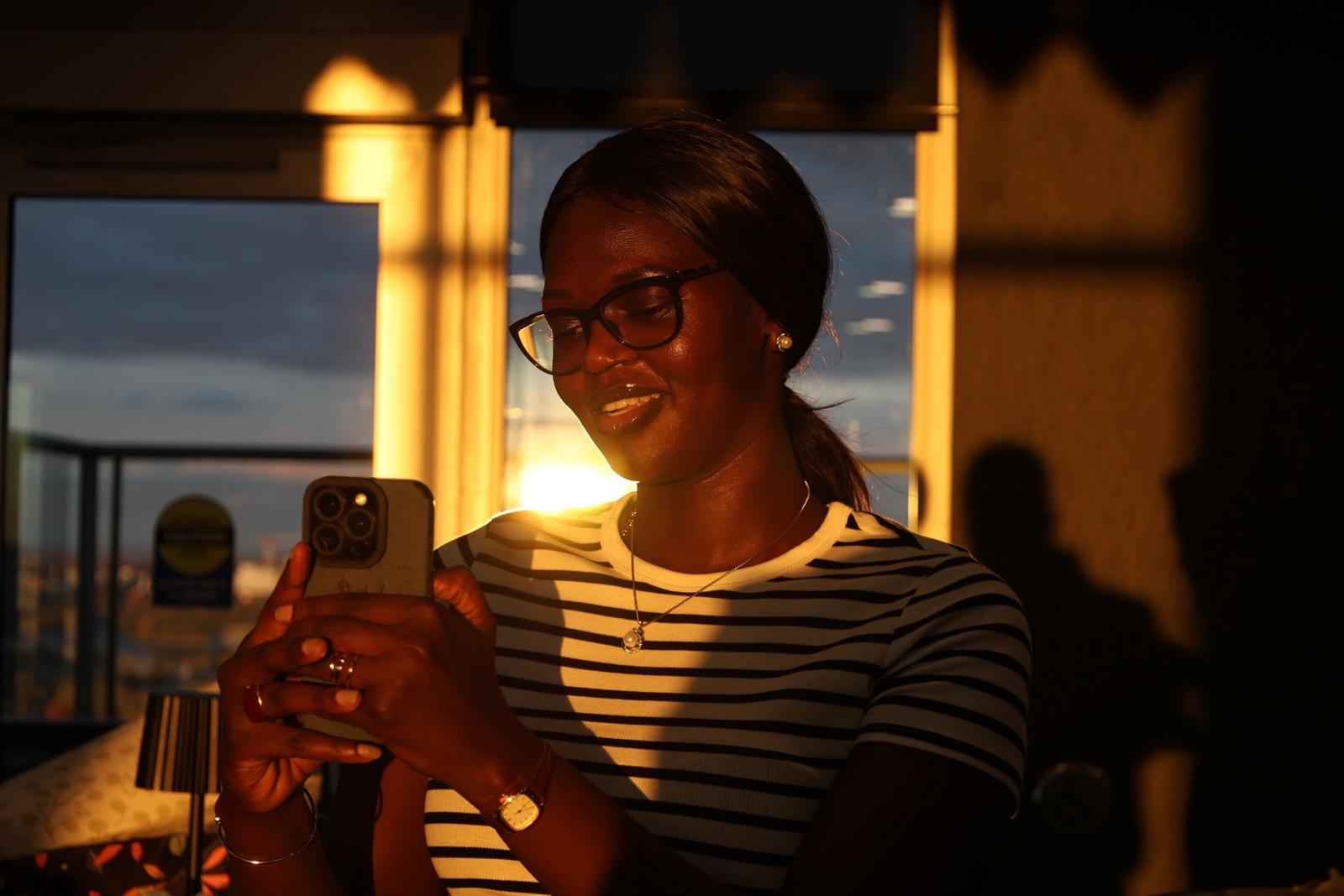 Community member taking a photo during golden hour